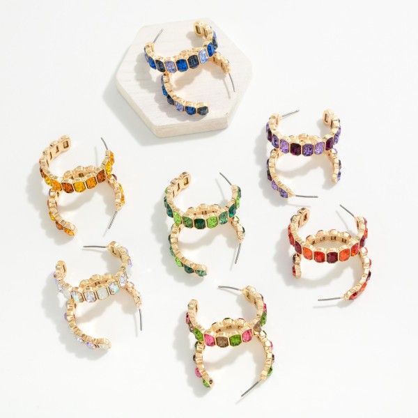 Crystal Lined Hoop Earrings with a row of round faceted stones set in polished bezels all the way around a slim open hoop. Post backs and a lightweight build make them easy to wear from day to night. A sparkling choice for holiday events, weddings, date nights and everyday glam. Classic jeweled hoops at an easy price that keep boutiques reordering.