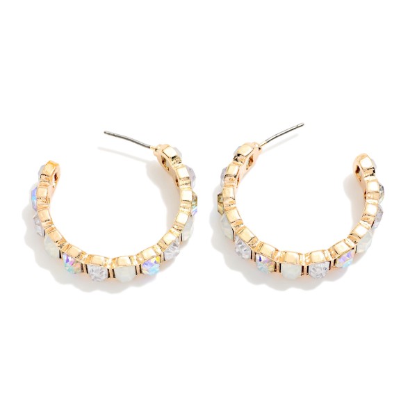 Crystal Lined Hoop Earrings with a row of round faceted stones set in polished bezels all the way around a slim open hoop. Post backs and a lightweight build make them easy to wear from day to night. A sparkling choice for holiday events, weddings, date nights and everyday glam. Classic jeweled hoops at an easy price that keep boutiques reordering.