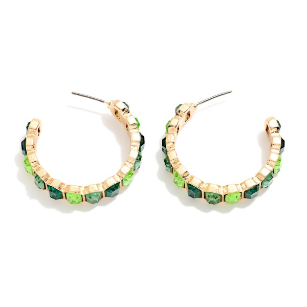 Crystal Lined Hoop Earrings with a row of round faceted stones set in polished bezels all the way around a slim open hoop. Post backs and a lightweight build make them easy to wear from day to night. A sparkling choice for holiday events, weddings, date nights and everyday glam. Classic jeweled hoops at an easy price that keep boutiques reordering.