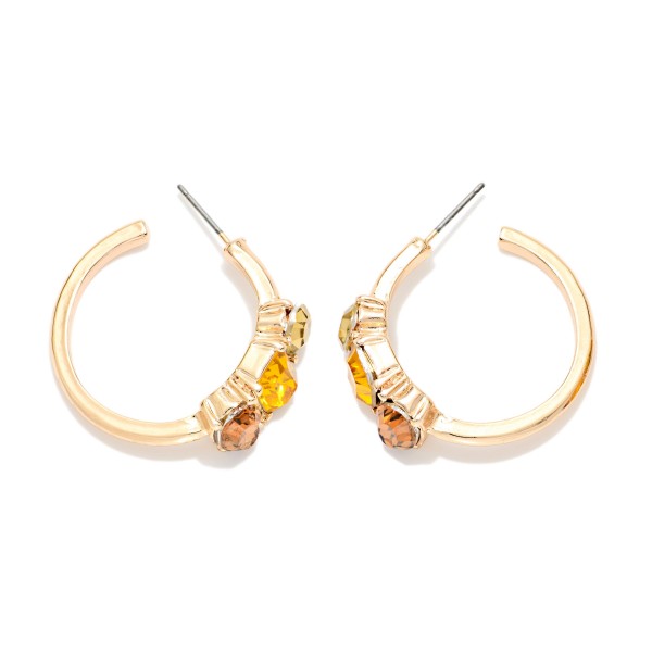 Crystal Accent Hoop Earrings with a polished open hoop and a cluster of three faceted stones set in raised bezels along the front. Post backs and a lightweight build keep them comfortable from morning to night. A pretty upgrade for holiday parties, date nights and everyday sparkle. Jeweled hoops are a seasonal favorite, and this pair sells at an easy impulse price.