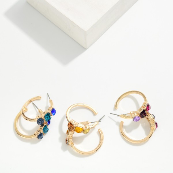 Crystal Accent Hoop Earrings with a polished open hoop and a cluster of three faceted stones set in raised bezels along the front. Post backs and a lightweight build keep them comfortable from morning to night. A pretty upgrade for holiday parties, date nights and everyday sparkle. Jeweled hoops are a seasonal favorite, and this pair sells at an easy impulse price.