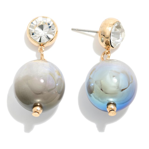 Crystal Stud Pearl Drop Earrings featuring a round bezel set crystal stud with an oversized lustrous pearl bead suspended below. The pairing of sparkle and soft sheen feels polished and elegant without being fussy. Post backs keep them secure and comfortable. Perfect for holiday parties, weddings, and date nights, and a strong gift option offered in several pearl finishes.