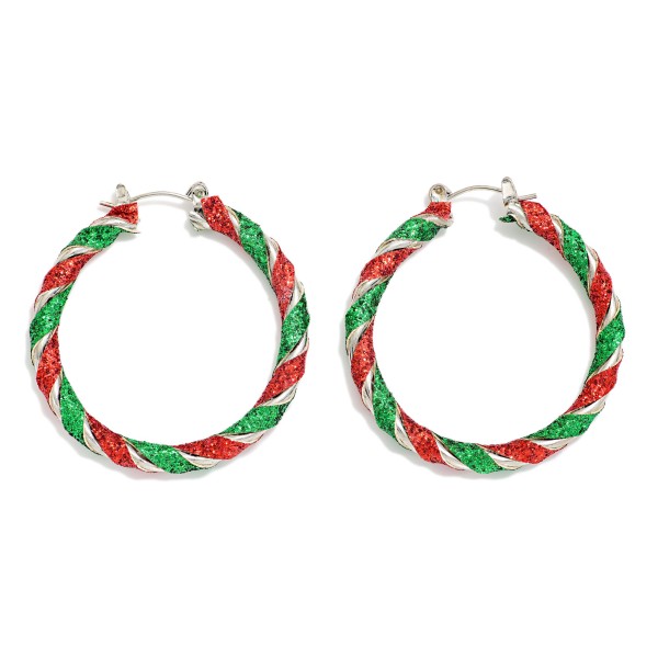 Candy Cane Glitter Hoop Earrings with a twisted stripe design wrapped in sparkling glitter and finished in polished metal. The rope twist shape puts a festive spin on an everyday hoop and stays light enough for all day wear. Perfect for holiday parties, school programs and Christmas shopping trips. A cheerful hoop that turns heads at the register and sells fast through December.