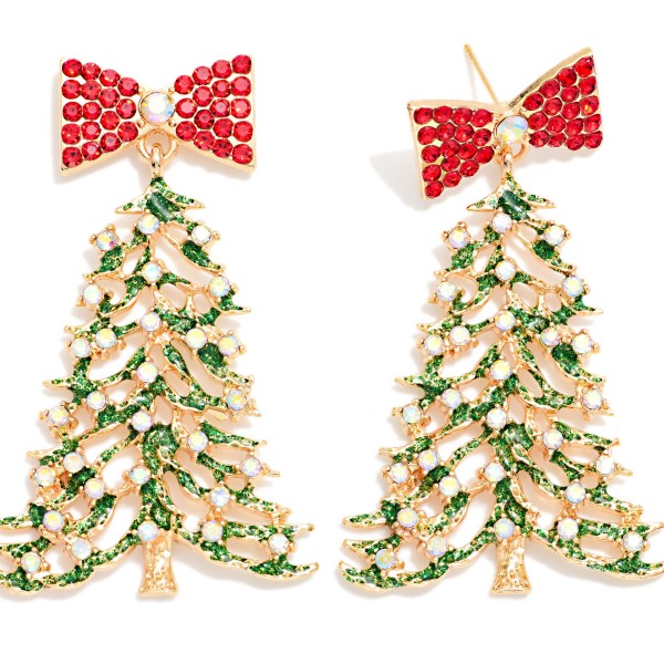 Rhinestone Bow Christmas Tree Drop Earrings featuring a sparkling bow post top that suspends an open filigree tree trimmed with enamel garland and twinkling rhinestones. Dramatic yet wearable, these statement earrings bring instant holiday glam to party dresses, cozy sweaters, and festive family photos. A showstopping seasonal style that catches the light from across the room. Display near the register for a merry add on that sells through quickly from Thanksgiving to New Year's.