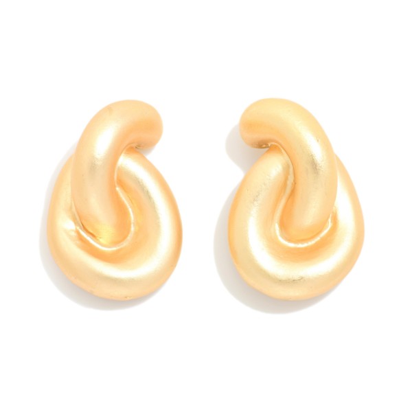 Puffy Twist Stud Earrings with a sculpted, curved knot design in a smooth matte finish. The rounded shape feels soft and modern while still making a bold statement close to the ear. Post backs for secure, comfortable wear. A chunky metal stud that pairs with everything from tees to evening wear, ideal for customers who love bold but easy everyday earrings.
