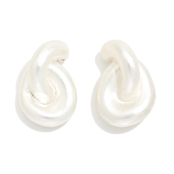 Puffy Twist Stud Earrings with a sculpted, curved knot design in a smooth matte finish. The rounded shape feels soft and modern while still making a bold statement close to the ear. Post backs for secure, comfortable wear. A chunky metal stud that pairs with everything from tees to evening wear, ideal for customers who love bold but easy everyday earrings.