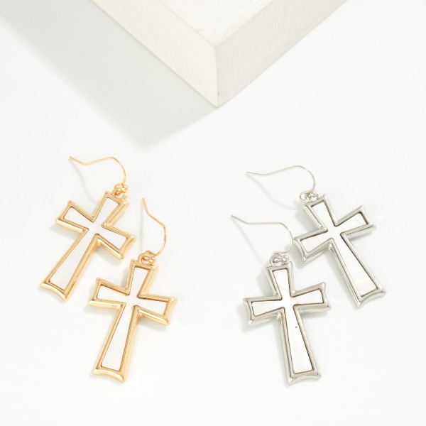 Pearlescent Cross Drop Earrings featuring a framed cross with a shimmering pearl look inlay, hanging from fishhook wires. The soft luster gives a classic cross design a fresh, elegant feel. Lightweight and comfortable for all day wear. A meaningful gift for baptisms, first communions, and Easter, and a steady seller for faith inspired boutique displays.
