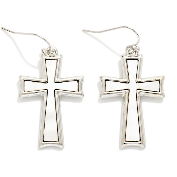 Pearlescent Cross Drop Earrings featuring a framed cross with a shimmering pearl look inlay, hanging from fishhook wires. The soft luster gives a classic cross design a fresh, elegant feel. Lightweight and comfortable for all day wear. A meaningful gift for baptisms, first communions, and Easter, and a steady seller for faith inspired boutique displays.