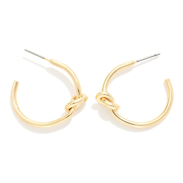 Knotted Open Hoop Earrings featuring a polished tube hoop tied with a sculptural knot at the side. The knot detail adds a modern twist to a timeless hoop shape, making these easy to wear every day. Post backs for comfortable, secure wear. A versatile style that sells across ages and pairs well with the coordinating knot stud earrings and bangles.