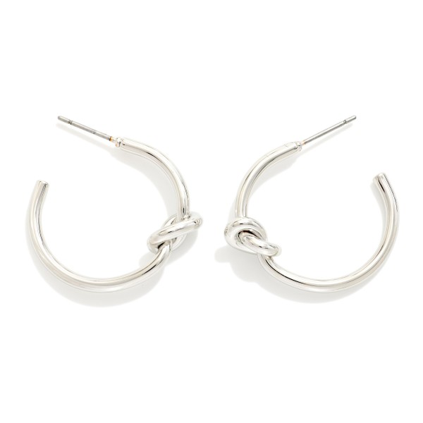 Knotted Open Hoop Earrings featuring a polished tube hoop tied with a sculptural knot at the side. The knot detail adds a modern twist to a timeless hoop shape, making these easy to wear every day. Post backs for comfortable, secure wear. A versatile style that sells across ages and pairs well with the coordinating knot stud earrings and bangles.