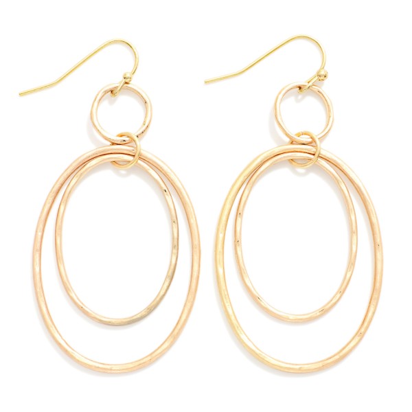 Hammered Double Oval Drop Earrings with layered open ovals, one smooth and one softly hammered, suspended from a small ring on fishhook wires. The airy design adds movement and texture without weight. Comfortable for all day wear. A modern metal earring that pairs effortlessly with casual and dressy outfits and works as an easy everyday bestseller.