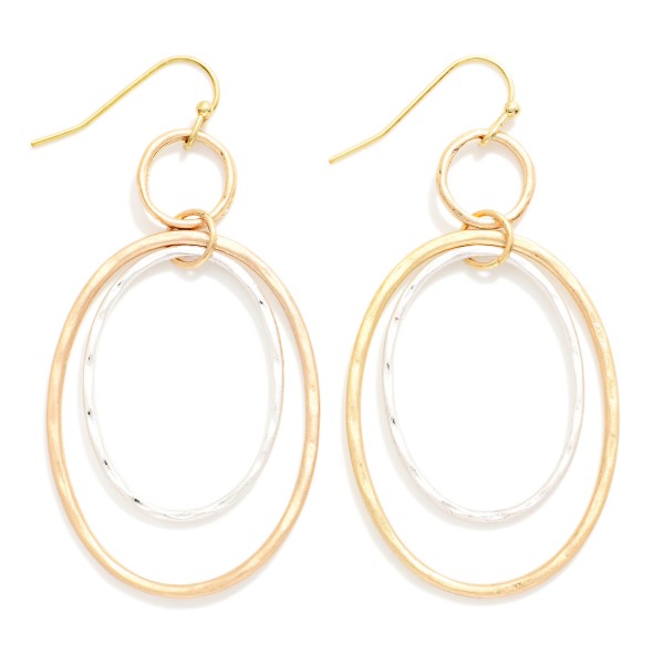 Hammered Double Oval Drop Earrings with layered open ovals, one smooth and one softly hammered, suspended from a small ring on fishhook wires. The airy design adds movement and texture without weight. Comfortable for all day wear. A modern metal earring that pairs effortlessly with casual and dressy outfits and works as an easy everyday bestseller.