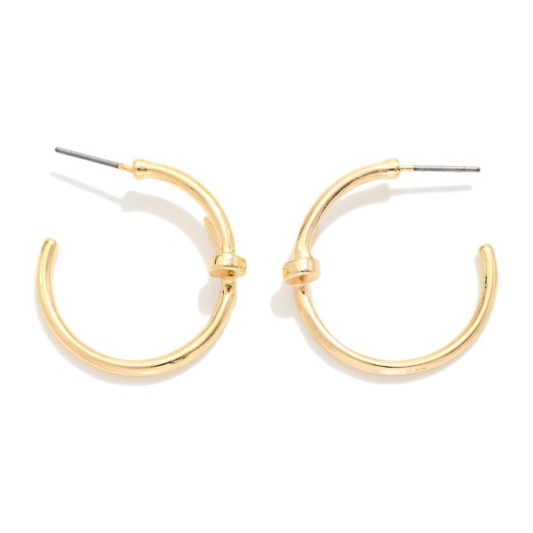Slim Knot Hoop Earrings with a smooth open hoop finished with a delicate knotted detail. The subtle twist updates a classic hoop and keeps it light and easy for everyday wear. Post backs for a secure, comfortable fit. A simple, polished earring that works for the office, weekends, and gifting, and pairs nicely with the coordinating knot bangles.