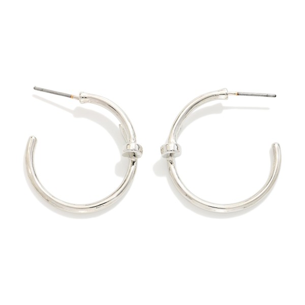 Slim Knot Hoop Earrings with a smooth open hoop finished with a delicate knotted detail. The subtle twist updates a classic hoop and keeps it light and easy for everyday wear. Post backs for a secure, comfortable fit. A simple, polished earring that works for the office, weekends, and gifting, and pairs nicely with the coordinating knot bangles.