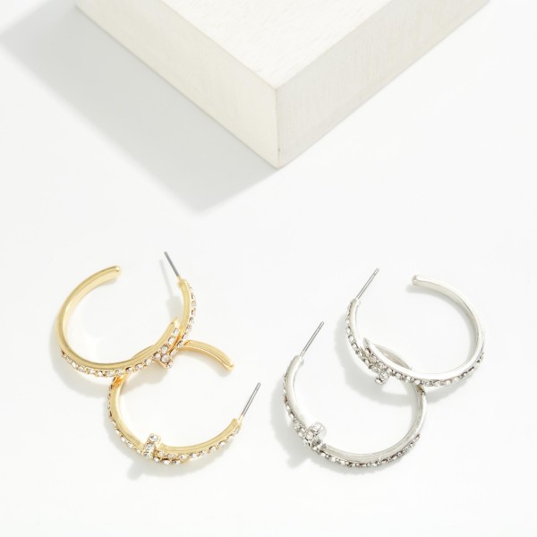Rhinestone Accent Hoop Earrings featuring an open hoop with a sparkling pave detail along the front and a textured edge. The rhinestone accent gives a classic hoop extra shine for evenings, holidays, and special events. Post backs for a secure, comfortable fit. A dressy hoop style at an accessible price that makes an easy gift and coordinates with other sparkle pieces on your display.