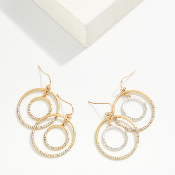 Rhinestone Double Hoop Drop Earrings featuring an open outer hoop framing a sparkling rhinestone inner ring, suspended from fishhook wires. The circle within a circle design adds dimension and a touch of shine without feeling heavy. Easy to dress up for holiday parties and events or wear every day. A sparkly, affordable style that makes a great gift and pairs with the coordinating pave circle pendants.