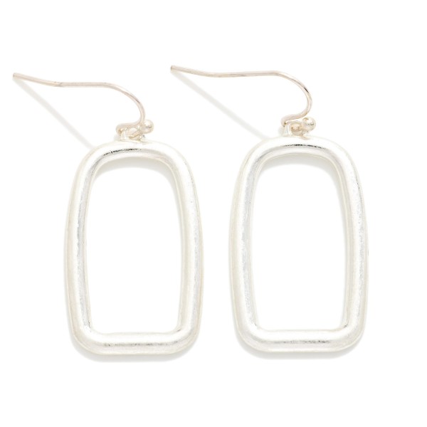 Open Rectangle Drop Earrings with a clean geometric outline in a soft brushed finish, hung from lightweight fishhook wires. The minimal, architectural shape feels modern and pairs with everything from workwear to weekend outfits. Light enough for all day comfort. A simple, on trend earring at an easy price point, perfect for building out an everyday metal earring display.