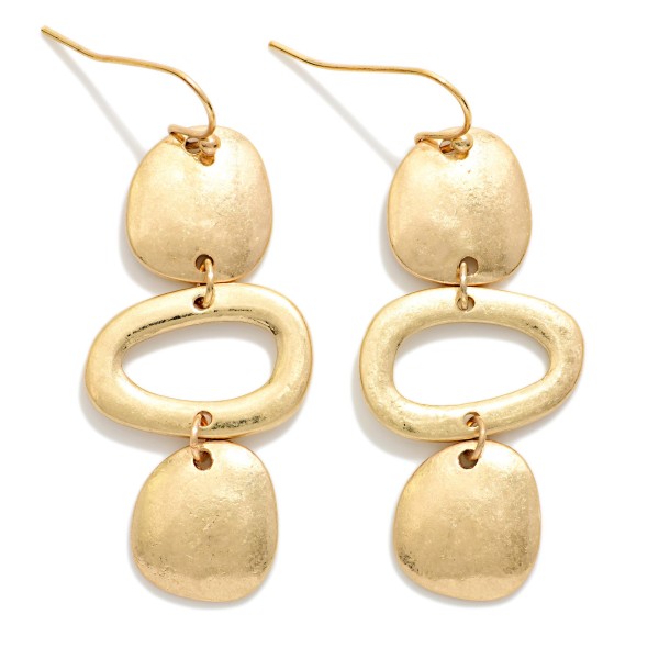 Hammered Geometric Drop Earrings featuring a linear stack of organic shaped discs and an open oval link in a worn metal finish. The artisan inspired texture gives these a collected, boho feel with plenty of movement. Fishhook wires keep them lightweight and comfortable. A statement earring that pairs effortlessly with denim, linen, and flowy dresses for an easy everyday look.
