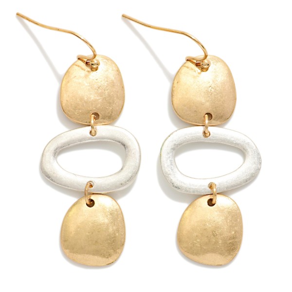 Hammered Geometric Drop Earrings featuring a linear stack of organic shaped discs and an open oval link in a worn metal finish. The artisan inspired texture gives these a collected, boho feel with plenty of movement. Fishhook wires keep them lightweight and comfortable. A statement earring that pairs effortlessly with denim, linen, and flowy dresses for an easy everyday look.