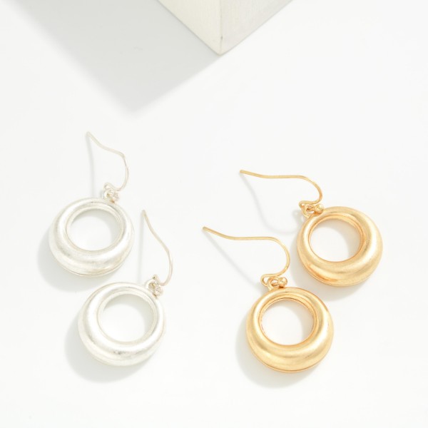 Organic Circle Drop Earrings with a sculpted open ring in a soft brushed finish, hanging from simple fishhook wires. The smooth, rounded shape feels modern and effortless for everyday wear. Lightweight enough for all day comfort. A versatile metal earring at an easy price point that pairs with any outfit and sells well as an impulse purchase near the register.