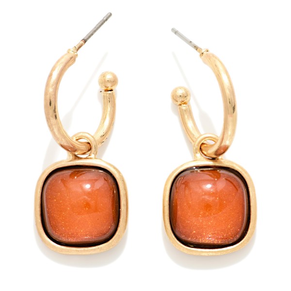 Cushion Stone Hoop Charm Earrings with a framed square cabochon stone that dangles from a polished open hoop. The bold stone and clean metal pairing makes these an easy statement for holiday parties, date nights, and dressing up everyday outfits. Lightweight post backs for comfortable wear. Offered in several stone options, they're a natural upsell alongside the coordinating square stone necklaces and bracelets.