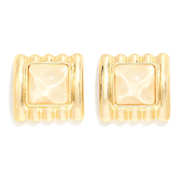 Square Stone Statement Stud Earrings with a pyramid cut cabochon set in a ribbed metal frame. The architectural ridges and sculpted stone give a retro glam look that elevates knits, button downs, and holiday party outfits. Post backs keep them secure and comfortable for all day wear. Chunky vintage inspired studs are trending this season, and this style offers a high impact look that boutique shoppers love to collect.