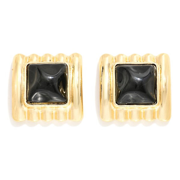 Square Stone Statement Stud Earrings with a pyramid cut cabochon set in a ribbed metal frame. The architectural ridges and sculpted stone give a retro glam look that elevates knits, button downs, and holiday party outfits. Post backs keep them secure and comfortable for all day wear. Chunky vintage inspired studs are trending this season, and this style offers a high impact look that boutique shoppers love to collect.