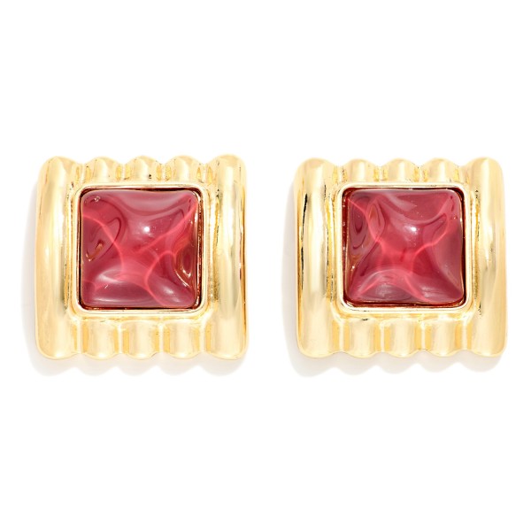Square Stone Statement Stud Earrings with a pyramid cut cabochon set in a ribbed metal frame. The architectural ridges and sculpted stone give a retro glam look that elevates knits, button downs, and holiday party outfits. Post backs keep them secure and comfortable for all day wear. Chunky vintage inspired studs are trending this season, and this style offers a high impact look that boutique shoppers love to collect.