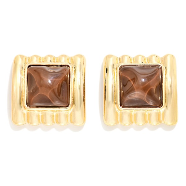 Square Stone Statement Stud Earrings with a pyramid cut cabochon set in a ribbed metal frame. The architectural ridges and sculpted stone give a retro glam look that elevates knits, button downs, and holiday party outfits. Post backs keep them secure and comfortable for all day wear. Chunky vintage inspired studs are trending this season, and this style offers a high impact look that boutique shoppers love to collect.
