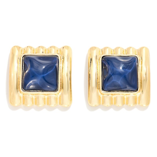 Square Stone Statement Stud Earrings with a pyramid cut cabochon set in a ribbed metal frame. The architectural ridges and sculpted stone give a retro glam look that elevates knits, button downs, and holiday party outfits. Post backs keep them secure and comfortable for all day wear. Chunky vintage inspired studs are trending this season, and this style offers a high impact look that boutique shoppers love to collect.