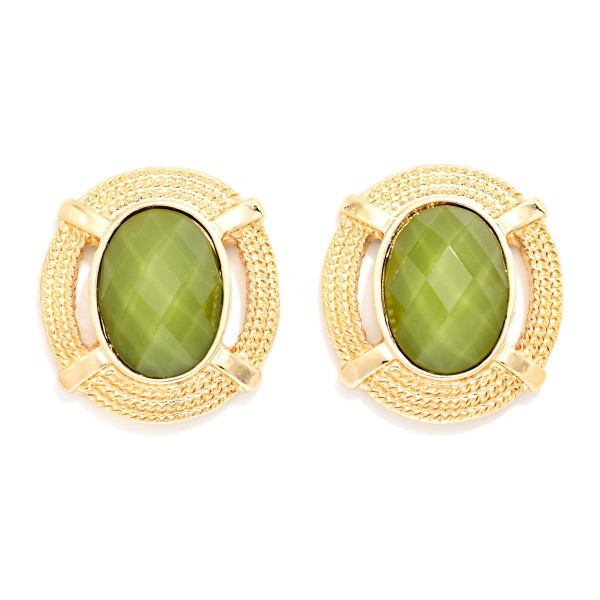 Oval Stone Statement Stud Earrings featuring a faceted oval cabochon set in a textured round metal frame with notched detailing. The decorative border adds vintage charm while the stone delivers rich, polished shine. Lightweight post backs make them comfortable from morning meetings through evening plans. Framed stone studs are a standout fall look and an easy upsell for customers building a curated earring wardrobe.