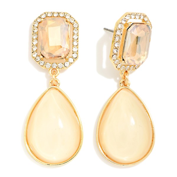 Crystal Halo Teardrop Statement Earrings with a rectangular step cut glass stone framed by a ring of sparkling rhinestones, suspending a glossy teardrop cabochon below. The mix of faceted sparkle and smooth polished drop gives an elegant, old Hollywood feel for weddings, holiday parties, and date nights. Post backs and a balanced weight keep them comfortable all evening. Glam drop earrings are a seasonal must have, and this design delivers a luxe look at a price that makes it an easy gift.