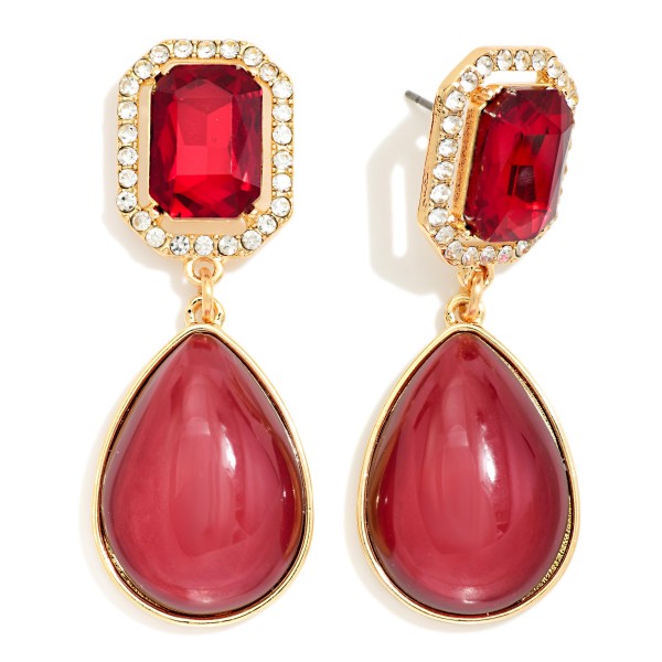 Crystal Halo Teardrop Statement Earrings with a rectangular step cut glass stone framed by a ring of sparkling rhinestones, suspending a glossy teardrop cabochon below. The mix of faceted sparkle and smooth polished drop gives an elegant, old Hollywood feel for weddings, holiday parties, and date nights. Post backs and a balanced weight keep them comfortable all evening. Glam drop earrings are a seasonal must have, and this design delivers a luxe look at a price that makes it an easy gift.