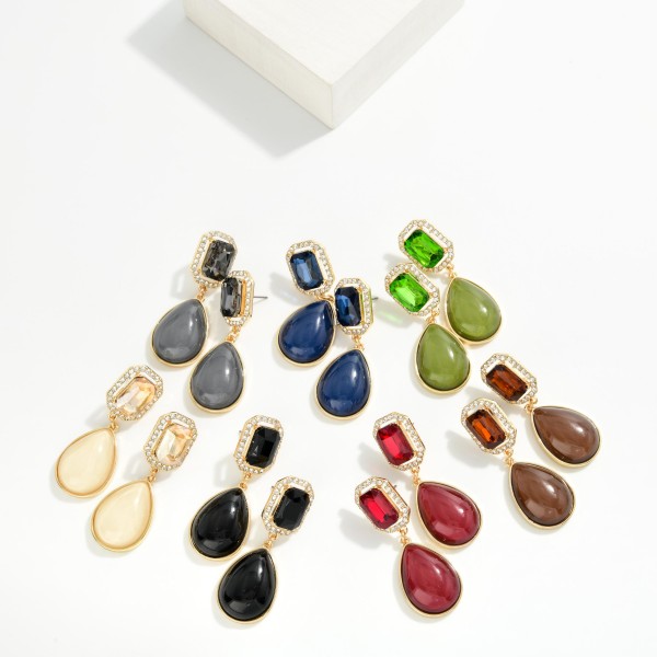 Crystal Halo Teardrop Statement Earrings with a rectangular step cut glass stone framed by a ring of sparkling rhinestones, suspending a glossy teardrop cabochon below. The mix of faceted sparkle and smooth polished drop gives an elegant, old Hollywood feel for weddings, holiday parties, and date nights. Post backs and a balanced weight keep them comfortable all evening. Glam drop earrings are a seasonal must have, and this design delivers a luxe look at a price that makes it an easy gift.