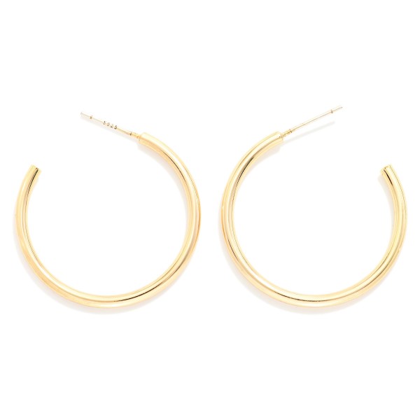 Large Thin Hoop Earrings with a smooth, polished finish and a lightweight open hoop silhouette on easy post backs. The generous diameter makes a statement while the slim profile keeps them light enough for all day comfort. Wear them with a sweater and jeans or dress them up for a night out. Timeless hoops are one of the most reordered jewelry basics, making this pair an essential for every boutique.