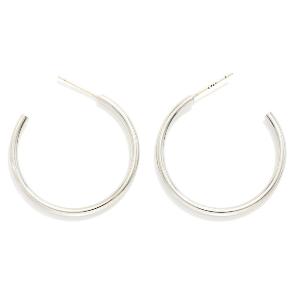 Large Thin Hoop Earrings with a smooth, polished finish and a lightweight open hoop silhouette on easy post backs. The generous diameter makes a statement while the slim profile keeps them light enough for all day comfort. Wear them with a sweater and jeans or dress them up for a night out. Timeless hoops are one of the most reordered jewelry basics, making this pair an essential for every boutique.