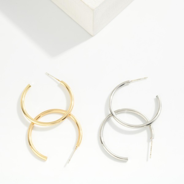 Large Thin Hoop Earrings with a smooth, polished finish and a lightweight open hoop silhouette on easy post backs. The generous diameter makes a statement while the slim profile keeps them light enough for all day comfort. Wear them with a sweater and jeans or dress them up for a night out. Timeless hoops are one of the most reordered jewelry basics, making this pair an essential for every boutique.