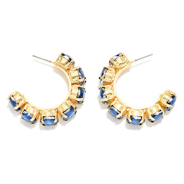 Rhinestone Station Hoop Earrings with faceted glass stones set in polished bezels around an open C hoop. The stones wrap the front of the hoop so sparkle shows from every angle, adding instant polish to casual looks and holiday party outfits alike. Lightweight post backs keep them comfortable all day. Jeweled hoops are a gift giving favorite, and this versatile style sells well across every age group.