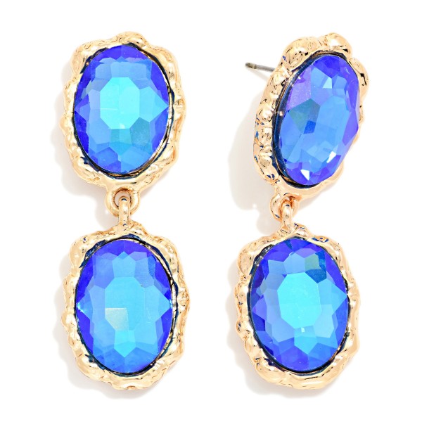 Oval Crystal Double Drop Earrings with two faceted glass stones stacked in organic, hammered style bezels. The textured settings give a vintage, heirloom feel while the oval stones deliver bold sparkle that frames the face. Lightweight post backs make them easy to wear from cocktail hour to the dance floor. Statement crystal earrings are a holiday season essential, and this design offers a high end look at an approachable boutique price.