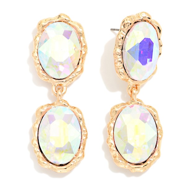 Oval Crystal Double Drop Earrings with two faceted glass stones stacked in organic, hammered style bezels. The textured settings give a vintage, heirloom feel while the oval stones deliver bold sparkle that frames the face. Lightweight post backs make them easy to wear from cocktail hour to the dance floor. Statement crystal earrings are a holiday season essential, and this design offers a high end look at an approachable boutique price.
