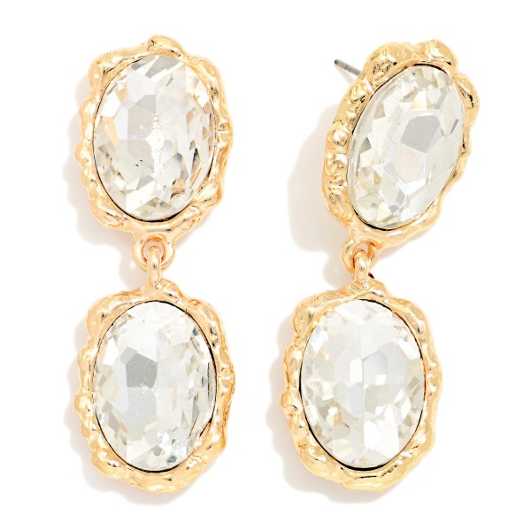Oval Crystal Double Drop Earrings with two faceted glass stones stacked in organic, hammered style bezels. The textured settings give a vintage, heirloom feel while the oval stones deliver bold sparkle that frames the face. Lightweight post backs make them easy to wear from cocktail hour to the dance floor. Statement crystal earrings are a holiday season essential, and this design offers a high end look at an approachable boutique price.
