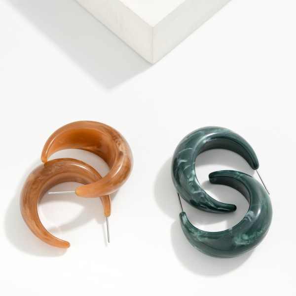 Chunky Marbled Resin Hoop Earrings with a thick, sculpted C shape and glossy swirled finish. Lightweight acetate keeps them comfortable despite their bold size. Perfect for fall outfits, sweater weather, and casual weekends. Statement resin hoops sell steadily in every season and make an easy add on for any boutique.