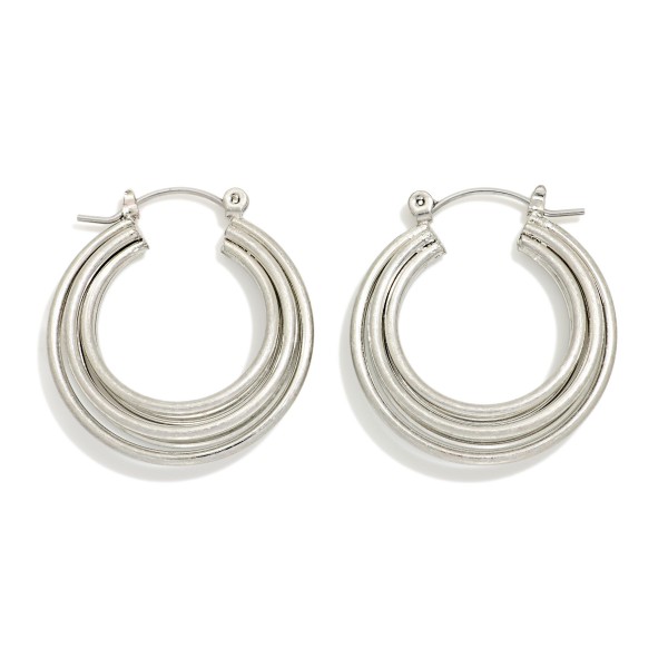 Ribbed Tube Hoop Earrings with a chunky, rounded profile and polished finish for a bold everyday look. Hinged hoop closures make them easy to put on and keep them secure all day. A versatile staple that pairs with everything from jeans and tees to dresses. Classic hoops are a year round best seller, and this textured update gives boutiques a fresh option to restock.