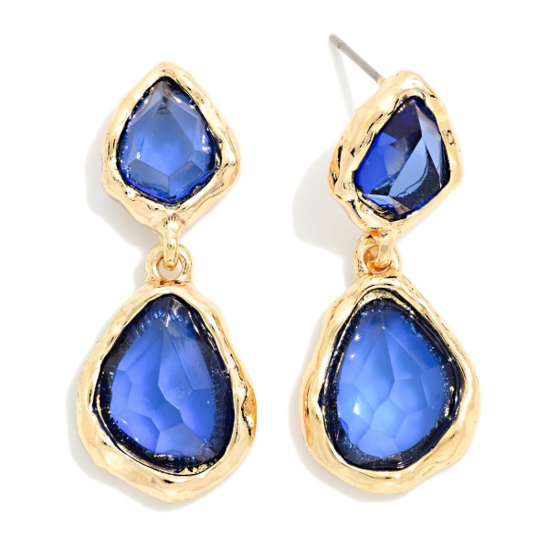 Double Glass Stone Drop Earrings pairing a smaller organic stone with a larger teardrop, each set in a polished bezel. The irregular faceting gives a soft, vintage glow that flatters every skin tone. Wear them to holiday parties, weddings, and dinners out. A gem inspired statement that adds sparkle to any outfit and sells quickly as a gift.