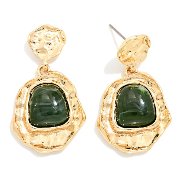 Hammered Frame Stone Drop Earrings with organic, textured settings surrounding a glossy marbled stone. The irregular shapes give them an artisan, vintage inspired feel that pairs well with fall knits and holiday dresses. Post backs keep them comfortable and secure. Bold yet wearable, these statement earrings are an easy upsell for customers shopping for something special.