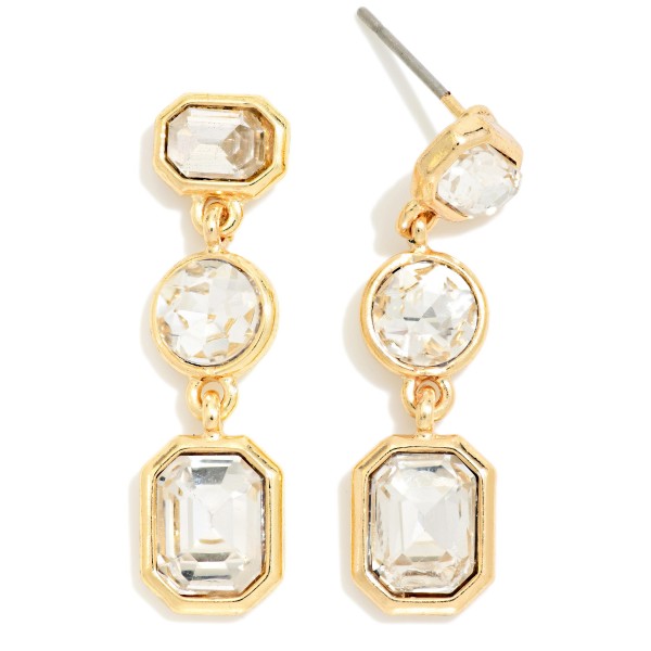 Linear Crystal Drop Earrings featuring three graduated glass stones in octagon, round, and emerald cut shapes set in polished prongs. The elongated design adds instant sparkle to holiday party looks, weddings, and evening events. Post backs keep them secure and comfortable. A classic, dressy style that customers buy for themselves and as gifts, making it a reliable seller through the holiday season.