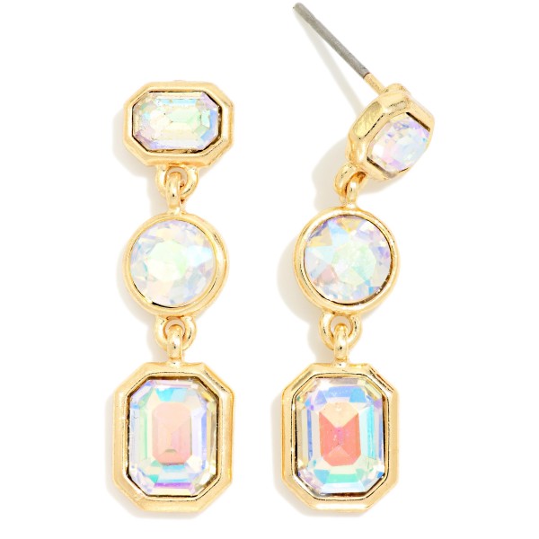 Linear Crystal Drop Earrings featuring three graduated glass stones in octagon, round, and emerald cut shapes set in polished prongs. The elongated design adds instant sparkle to holiday party looks, weddings, and evening events. Post backs keep them secure and comfortable. A classic, dressy style that customers buy for themselves and as gifts, making it a reliable seller through the holiday season.