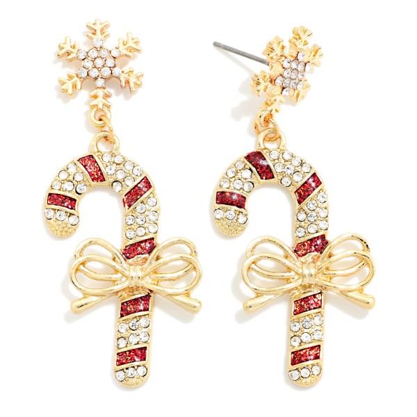 Rhinestone Candy Cane Drop Earrings with a sparkling bow at the center and a snowflake post on top. Each candy cane is outlined in shimmering stones for a glamorous take on a classic holiday treat. Ideal for Christmas parties, holiday concerts, date nights, and New Year's celebrations. A dressy holiday style with broad appeal that sells well as both a gift and a self purchase.