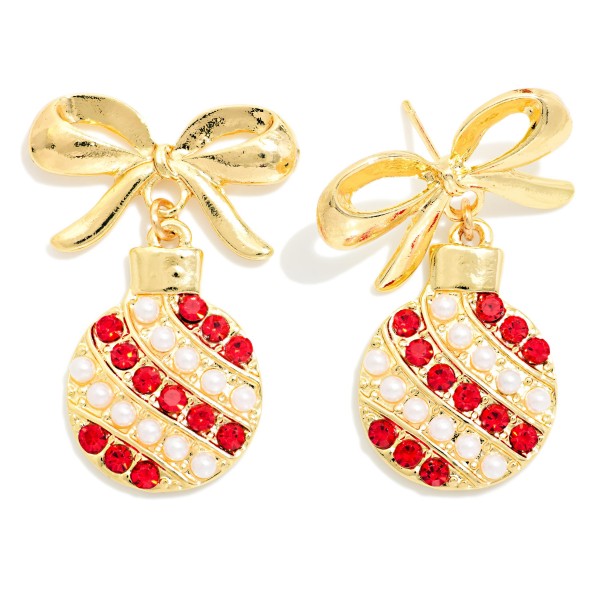Christmas Ornament Drop Earrings with a sculpted bow post and a round ornament striped in rows of faux pearls and sparkling rhinestones. Polished metal framing keeps the look elegant, and the post back makes them easy to wear all evening. Lovely for holiday parties, church services, family photos, and gift exchanges. A dressy holiday style that pairs with cozy sweaters or party dresses and sells well as a ready to wrap gift.