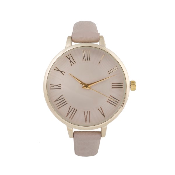 Taupe thin strap genuine leather band watch with a gold tone 1 1/2" face.